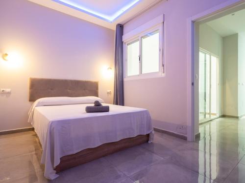a bedroom with a bed in a room with a window at Luxury Suite Fuengirola 1 in Fuengirola