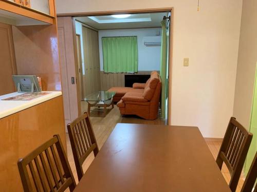 a dining room with a table and a chair at Yado wa Good Rich Aizumi - Vacation STAY 30409v in Ōtera