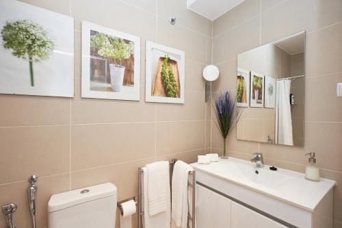 a bathroom with a white toilet and a sink at Villa Lunae - Sintra Flats in Sintra