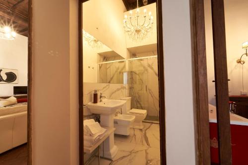 a bathroom with a toilet and a sink at Castello del Capitano delle Artiglierie in Castrocaro Terme