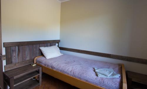 a small bed in a room with two pillows on it at Sodyba Ignė in Druskininkai