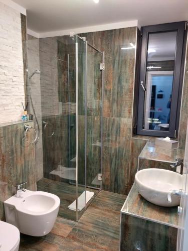 a bathroom with a sink and a glass shower at Bluemarina Apartamente in Mamaia