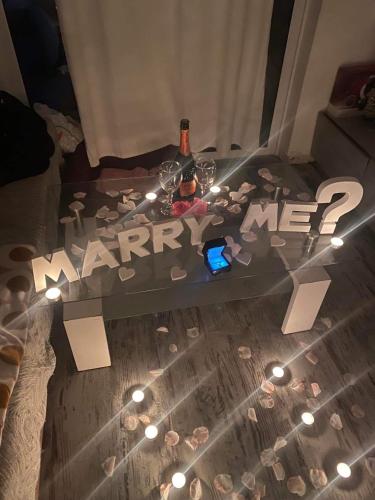 a glass table with a bottle of wine and a bottle of wine at Popasul Dacilor in Predeluţ