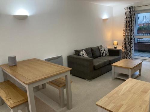 a living room with a couch and a table at Apartment D102 in Kingsthorpe