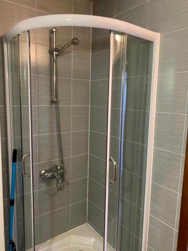 a shower with a glass door in a bathroom at Belvedere luxury apartment in Bansko