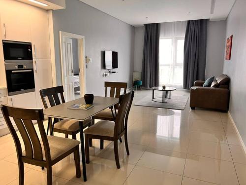 a living room with a table and chairs in a room at iTowers luxurious 1-Bedroom apartment- 15th Floor in Gaborone