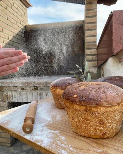 a table with three breads on a cutting board at B&B Fontanelle in Alviano