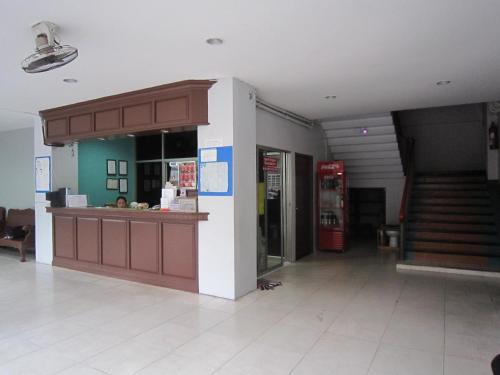 a gas station with a counter in a building at Pakchong Phubade Hotel in Pak Chong