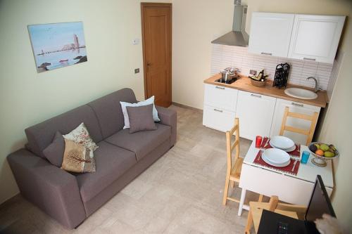 a living room with a couch and a table at Residence Le Lumie in Trapani