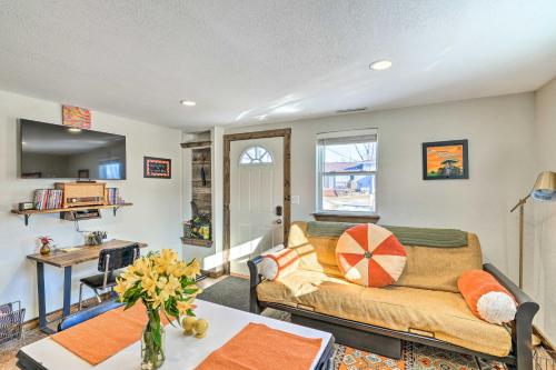 a living room with a couch and a table at Kid-Friendly House about 8 Mi to Cedar Rapids! in Cedar Rapids