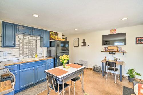 a kitchen with blue cabinets and a table at Kid-Friendly House about 8 Mi to Cedar Rapids! in Cedar Rapids