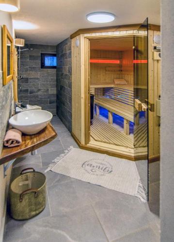 a bathroom with a sink and a glass shower at Chalupa Tomas Ždiar in Ždiar