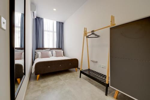 a small bedroom with a bed and a window at Perfect Location, Idyllic 2BR Apartment in Sliema