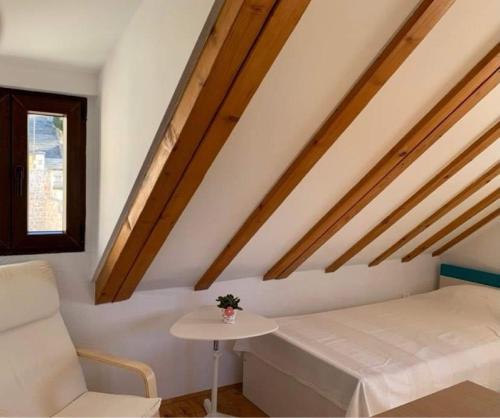 a room with a bed and a table and a window at Inevig Holiday home in Rogoznica