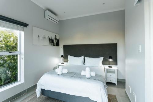 a bedroom with a large bed with two white towels at Kingswood Manor No.17 in George