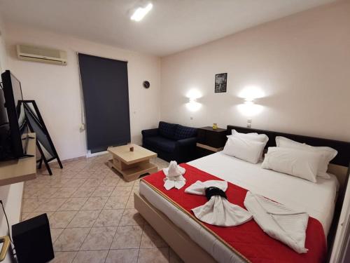 a hotel room with a bed with towels on it at Studios Nelli Alonissos in Patitiri