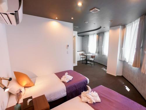a hotel room with two beds and a table at Hotel S-Presso Central - Vacation STAY 9443 in Osaka