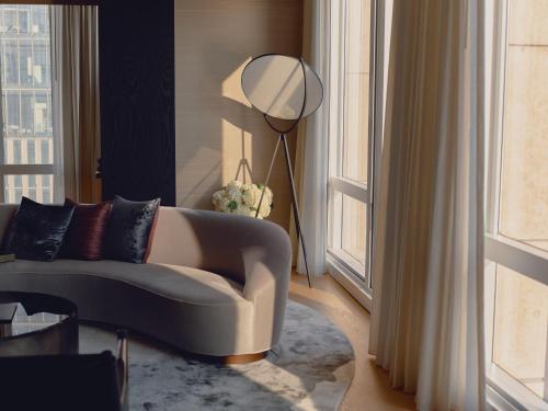 a living room with a couch and a floor lamp at Equinox Hotel New York in New York