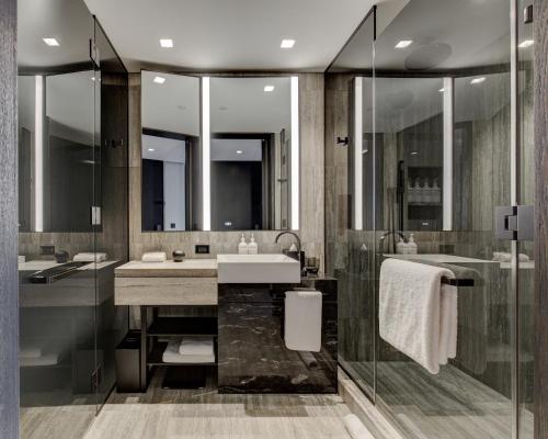 a bathroom with a sink and a shower at Equinox Hotel New York in New York