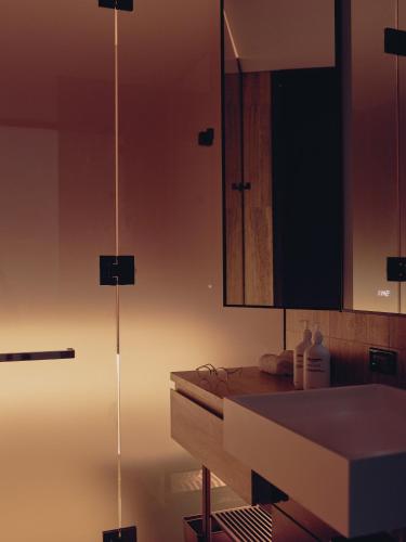 a bathroom with a sink and a mirror at Equinox Hotel New York in New York