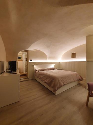 a bedroom with a bed and a television in it at Casa De Giorgis in Aosta
