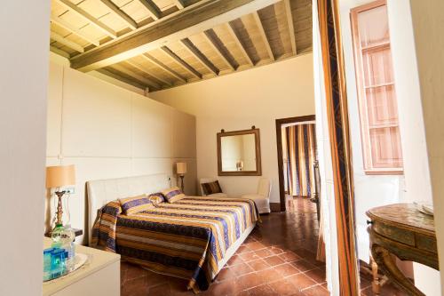 a bedroom with a bed and a mirror at Castello del Capitano delle Artiglierie in Castrocaro Terme