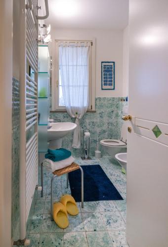 a bathroom with a sink and a toilet at B&B LA VILLA in Forlì