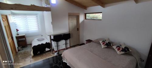 a bedroom with a bed with a cow on it at EkoClub in Paine
