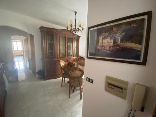 a living room with a painting on the wall at Dorgali Apartment La Marmora in Dorgali