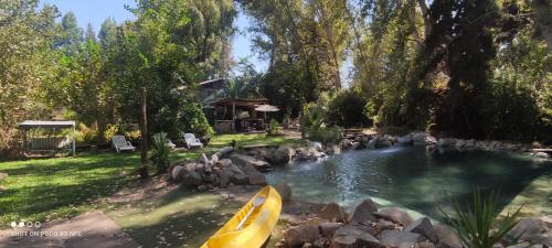 a swimming pool with a yellow kayak in a yard at EkoClub in Paine