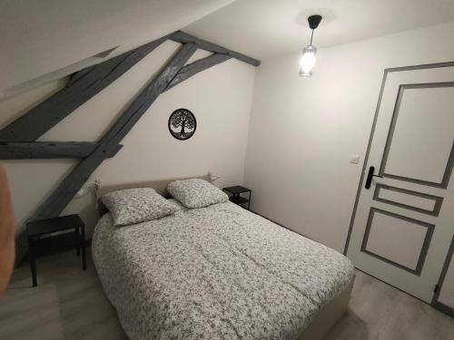 a bedroom with a large bed in a attic at LA MACHINE Sous Combles in La Machine
