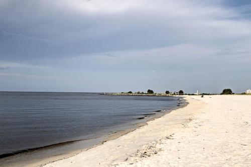 a sandy beach with the ocean and the sky at Spacious Biloxi Getaway with Pools and Beach Access! in Biloxi