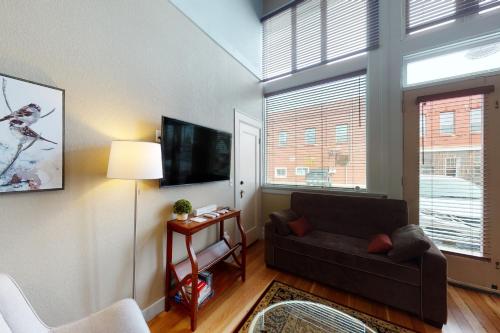 a living room with a couch and a flat screen tv at The Loft Downtown in Joseph