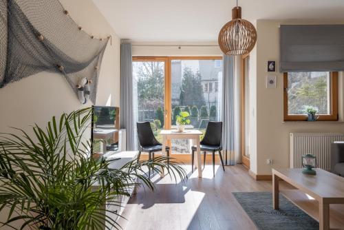 a living room with chairs and a table at Apartamenty Maestro in Gdynia