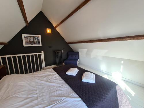 a bedroom with a bed with two towels on it at Studio12A in Domburg