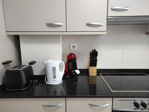 a kitchen counter with a coffee maker and a toaster at Paradise Village Port Aventuras in Salou