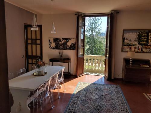 a living room with a table and a large window at Villa Lia - Apartment in Villa with private garden and Pool in Florence