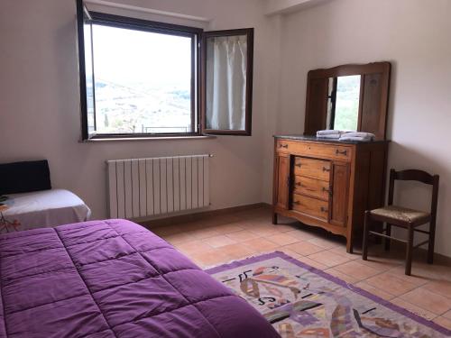 um quarto com uma cama, uma cómoda e um espelho em La Casa di Demetra. Un Paradiso tra gli Olivi. em Montecchio
