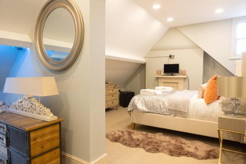 a bedroom with a bed and a mirror at Vale House in Belvoir
