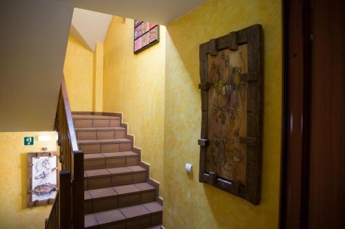 a staircase in a building with a door and a stair case at Hostal Rural La Tintoreria in Villablino