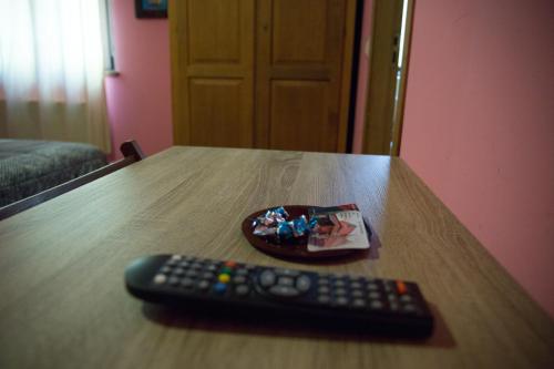 a remote control sitting on top of a wooden table at Hostal Rural La Tintoreria in Villablino
