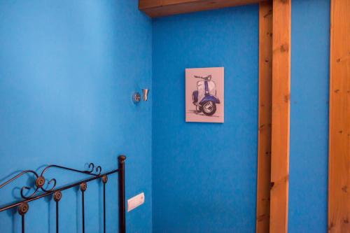 a blue wall with a picture of a scooter on it at Hostal Rural La Tintoreria in Villablino
