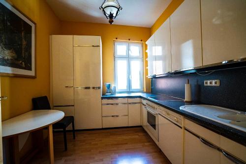 una cocina con armarios blancos y una ventana en Pension am Dom en Schwerin