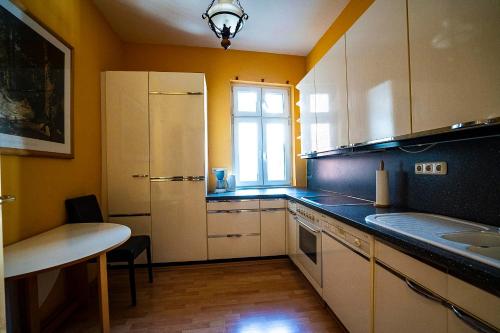 a kitchen with white cabinets and a window at Pension am Dom in Schwerin