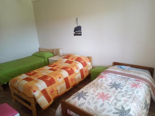 two beds sitting next to each other in a room at Luz de las Sierras 2 in Arroyo de Los Patos