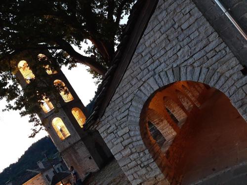 a brick wall with a clock tower in the background at Lichovo in Papigko