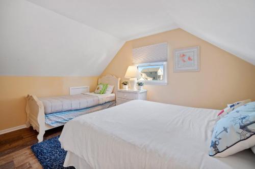 a bedroom with two beds and a couch and a window at ⭐️The Lucky 7 Beach House⭐️Water view⭐️4 bedroom⭐️ in Brigantine