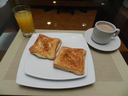 a plate with two pieces of toast and a cup of coffee at Hotel Palonegro in Bucaramanga