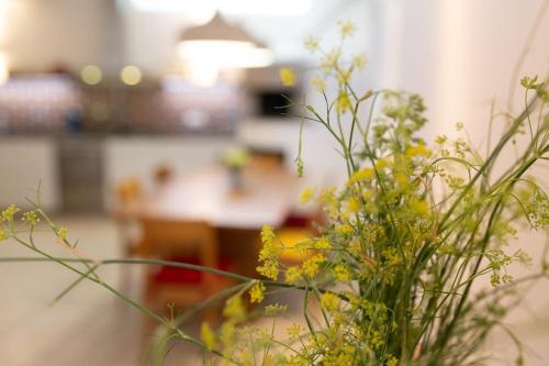 a vase filled with yellow flowers on a table at Amalfi Coast, Positano, Sorrento, Capri, Garden, Villa Carcara in Colli di Fontanelle
