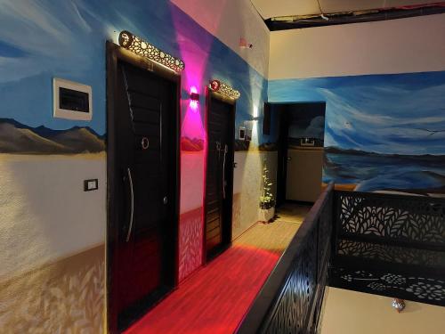 a room with a door and a painting on the wall at Shabana House in Dahab